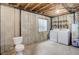 Unfinished basement featuring a toilet and laundry area, offering potential for customization at 4504 S Cimmarron Cir # D, Aurora, CO 80015
