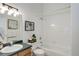 Bright bathroom featuring a tub with shower, and a vanity with ample lighting at 4504 S Cimmarron Cir # D, Aurora, CO 80015