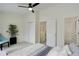 Light-filled bedroom with carpet, closet, ensuite bathroom, ceiling fan, and comfortable seating and decor at 4504 S Cimmarron Cir # D, Aurora, CO 80015