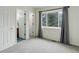 Bedroom with plush carpet, window with curtains, and doors to closet and bath at 4504 S Cimmarron Cir # D, Aurora, CO 80015