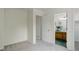 Bedroom featuring carpet, access to the bathroom, and lots of natural light at 4504 S Cimmarron Cir # D, Aurora, CO 80015