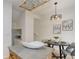 Dining area with modern light fixture, art on the wall, island with stone countertop, and carpeted stairs at 4504 S Cimmarron Cir # D, Aurora, CO 80015