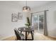 Cozy dining area with modern table set, art on the wall, and a sliding door to a small deck at 4504 S Cimmarron Cir # D, Aurora, CO 80015