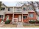 Inviting townhome featuring a brick facade, balcony, and well-maintained landscaping and pleasing curb appeal at 4504 S Cimmarron Cir # D, Aurora, CO 80015