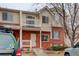 Charming townhome with brick facade, upper balcony, and manicured landscaping at 4504 S Cimmarron Cir # D, Aurora, CO 80015