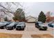 Residential parking area showing a variety of parked cars and leafless trees at 4504 S Cimmarron Cir # D, Aurora, CO 80015