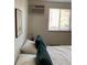 Bright bedroom with natural light, a minimalist design, and a comfortable bed for peaceful sleep at 155 S Pennsylvania St # 209, Denver, CO 80209