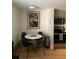 Bright dining area with a modern table, stylish chairs, and view into the kitchen at 155 S Pennsylvania St # 209, Denver, CO 80209