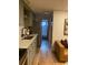 Well-designed kitchen with stainless steel appliances, quartz countertops, and a view of the hall bathroom at 155 S Pennsylvania St # 209, Denver, CO 80209