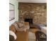 Cozy living room boasts a brick fireplace, comfortable seating, and warm, inviting decor for relaxation at 155 S Pennsylvania St # 209, Denver, CO 80209
