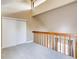 Lofted bedroom space with gray carpeting, bright light, and a spacious closet at 303 W Lehow Ave # 22, Englewood, CO 80110