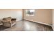 Cozy bedroom featuring wood-look flooring and a window with an outside view at 303 W Lehow Ave # 22, Englewood, CO 80110