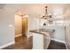 Bright dining area featuring wood floors and a unique modern light fixture at 303 W Lehow Ave # 22, Englewood, CO 80110