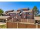 Attractive multi-level condo building featuring wood facade, gray trim, and well-kept landscaping at 303 W Lehow Ave # 22, Englewood, CO 80110