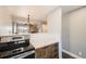 Stylish kitchen featuring stainless steel oven, white countertops and unique wood cabinets at 303 W Lehow Ave # 22, Englewood, CO 80110