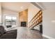 Cozy living room with wood floors, a sliding glass door and a wood accent wall with fireplace at 303 W Lehow Ave # 22, Englewood, CO 80110