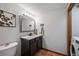Well-lit bathroom features a dark vanity with granite countertop and modern fixtures at 1217 Lincoln St, Longmont, CO 80501