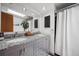 Bathroom featuring double sinks, granite counters, and modern fixtures at 1217 Lincoln St, Longmont, CO 80501