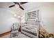 Cozy bedroom with neutral walls and a ceiling fan providing a comforting sleep environment at 1217 Lincoln St, Longmont, CO 80501