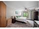 Cozy bedroom with neutral tones, a comfortable bed, and large window views at 1217 Lincoln St, Longmont, CO 80501