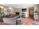 Dining area with an elegant brick fireplace, large picture window, and wood trim at 1217 Lincoln St, Longmont, CO 80501