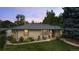 A charming single story brick home, complemented by a lush front lawn and vibrant garden at 1217 Lincoln St, Longmont, CO 80501