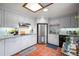 Bright kitchen featuring white cabinets, stainless steel appliances, and tile flooring at 1217 Lincoln St, Longmont, CO 80501