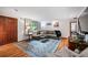 Inviting living room featuring hardwood floors, a cozy sofa, and ample natural light at 1217 Lincoln St, Longmont, CO 80501