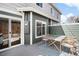Cozy back patio featuring outdoor seating, access to the home, and a privacy fence at 3402 N Clayton St, Denver, CO 80205