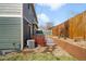 Landscaped backyard with a patio, stone pathway and well maintained wooden fence at 3402 N Clayton St, Denver, CO 80205
