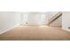 Spacious basement featuring neutral walls, carpet, staircase, and two windows providing ample natural light at 3402 N Clayton St, Denver, CO 80205