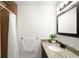 Bright bathroom features a granite countertop, vanity, and shower with neutral earth tone finishes at 3402 N Clayton St, Denver, CO 80205