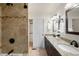 Bathroom boasts a granite countertop, double sinks, and tiled shower with a sliding door to the walk-in closet at 3402 N Clayton St, Denver, CO 80205