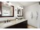 Bathroom features double sinks with granite countertop, two mirrors with dark wood frames, and stylish light fixtures at 3402 N Clayton St, Denver, CO 80205