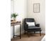 Comfortable reading nook with a gray arm chair, white lumbar pillow, and modern wood and metal table at 3402 N Clayton St, Denver, CO 80205