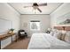Serene bedroom featuring a ceiling fan, desk, sitting chair and a window with a view at 3402 N Clayton St, Denver, CO 80205
