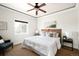 Cozy bedroom with a ceiling fan, comfortable bed, and ample natural light from the window at 3402 N Clayton St, Denver, CO 80205