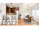 Open kitchen and dining area with stylish bar stools and stainless steel appliances at 3402 N Clayton St, Denver, CO 80205