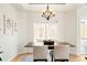 Sun-drenched dining room featuring a modern chandelier, neutral walls, and a large window overlooking the backyard at 3402 N Clayton St, Denver, CO 80205
