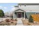Inviting home featuring a well-maintained lawn, covered porch, and modern front door at 3402 N Clayton St, Denver, CO 80205