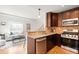 Open-concept kitchen with stainless steel appliances, granite countertops, and a view of the living area at 3402 N Clayton St, Denver, CO 80205