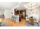 Open kitchen and dining area with granite countertops, stainless appliances, and wood floors at 3402 N Clayton St, Denver, CO 80205