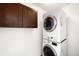 Efficient laundry area featuring a stackable washer/dryer and storage cabinets at 3402 N Clayton St, Denver, CO 80205