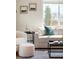 Comfortable living room with neutral tones, modern furniture, and ample natural light from the window at 3402 N Clayton St, Denver, CO 80205