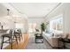 Open living space featuring a modern kitchen bar, hardwood floors, and a bright sitting area at 3402 N Clayton St, Denver, CO 80205
