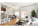 Modern living area features a bar, dining table, and sitting area with lots of natural light at 3402 N Clayton St, Denver, CO 80205