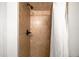 Close up view of tiled shower with bronze fixtures and shower curtain at 3402 N Clayton St, Denver, CO 80205