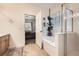 Bright bathroom with a soaking tub, shower, tile floors, and adjacent doorway to the main bedroom at 12 Apache Plume St, Brighton, CO 80601