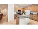 Bright kitchen featuring a center island, tiled floors, and ample cabinetry at 12 Apache Plume St, Brighton, CO 80601