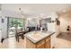 Open concept kitchen with a sink island, stainless steel appliances, and adjacent dining and living areas at 12 Apache Plume St, Brighton, CO 80601